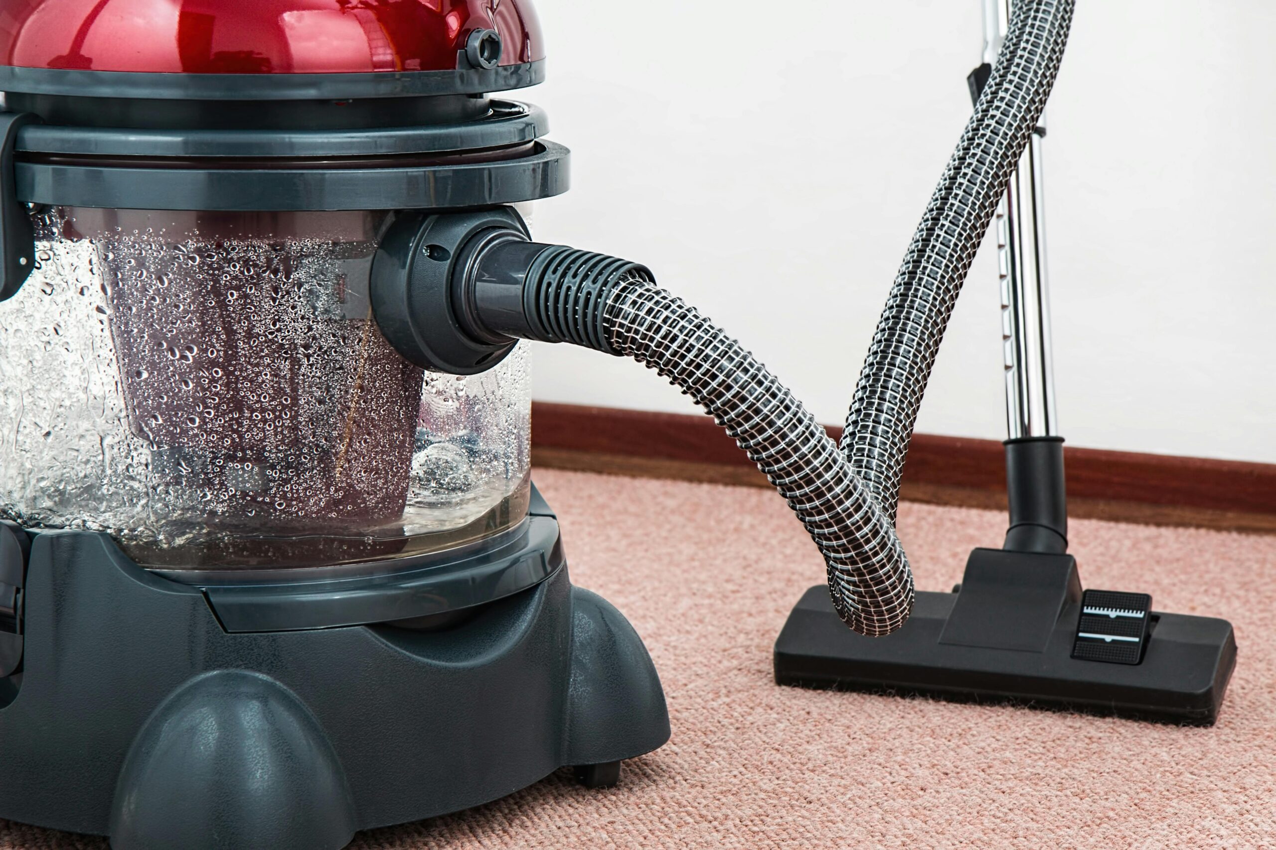 Close-up of a water filtration vacuum cleaner on a carpeted floor